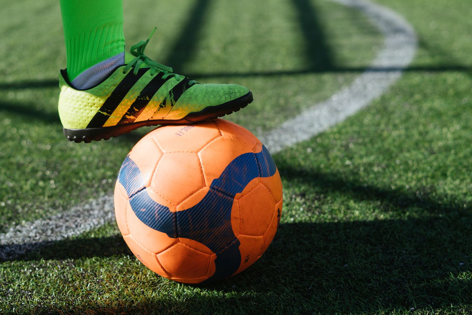 Football boot on the ball at the touchline